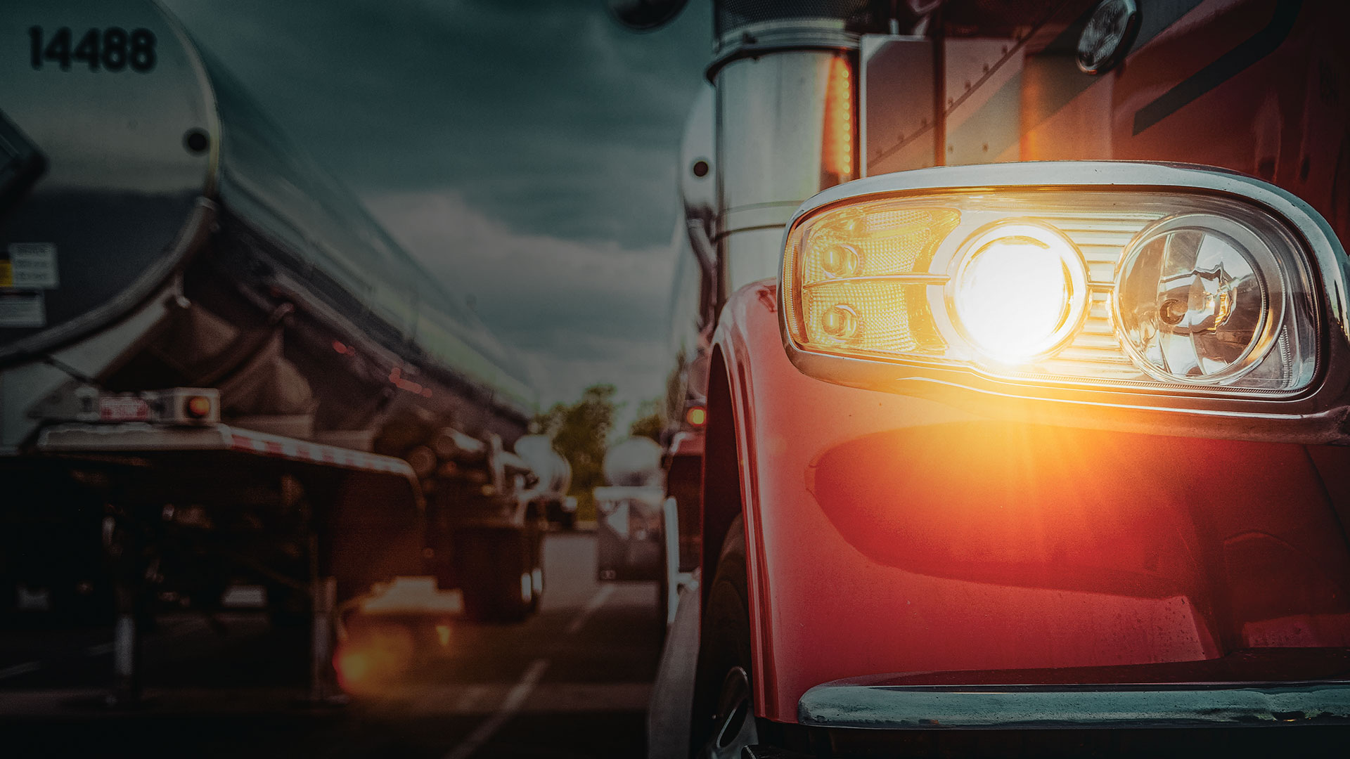 Red semi truck of the 10-65 Logistics shipping and transportation fleet drives nationwide and regional route in the rain